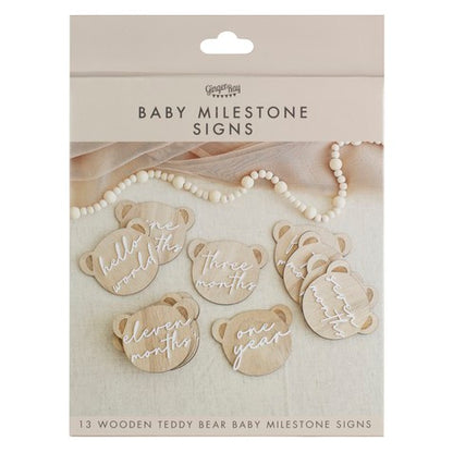 pregnancy milestone discs and baby milestone discs innthe shape of a teddy head on wood
