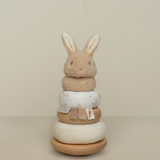 bunny stacker with a soft fluffy bunny head and wooden stacking rings on a wooden rocker base