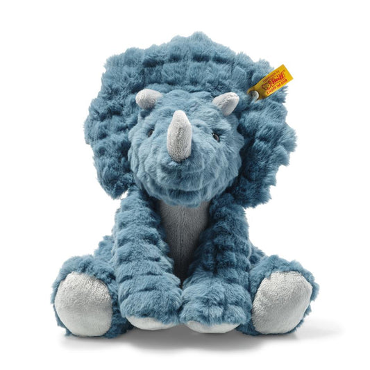 soft cuddly dinosaure in blue with textured fabric, white soft horn and Steiff button in ear