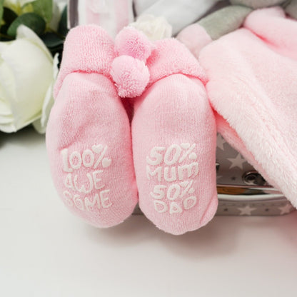 Small gift case with baby pink socks with cute writing on the sole, pink muslin, white baby knot hat, pink elephant baby comforter