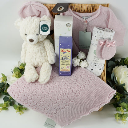 Willow baby hamper basket with pink cashmere baby set including baby cashmere cardigan, baby cashmere hat, baby cashmere mittens and baby cashmere shawl, white with grey elephants Ziggle muslin, soft white putty bear by Mary Meyer, Dew drops at Dawn by Little Butterfly London, Pillow spray  by Love boo