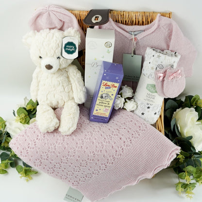 Willow baby hamper basket with pink cashmere baby set including baby cashmere cardigan, baby cashmere hat, baby cashmere mittens and baby cashmere shawl, white with grey elephants Ziggle muslin, soft white putty bear by Mary Meyer, Dew drops at Dawn by Little Butterfly London, Pillow spray by Love boo
