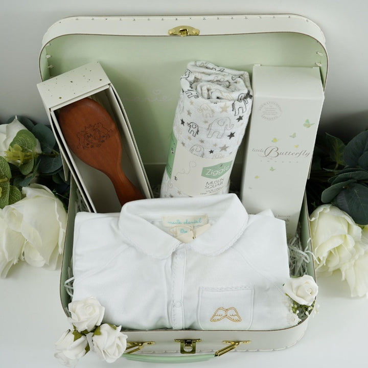 Luxury Marie- Chantal Baby Suitcase, Luxury Angel Wings white Baby sleepsuit. baby natural wooden hairbrush in heirloom box, White and grey muslin with elephants, Butterfly London baby toiletries