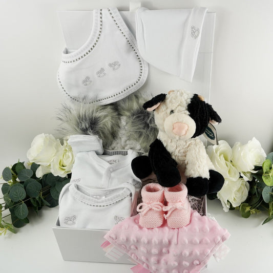 Baby Girl Gift Hamper with Rocking Horse Baby’s First Outfit, Cow Cuddly Toy, Pink Taggie, Baby Pom Pom Hat.