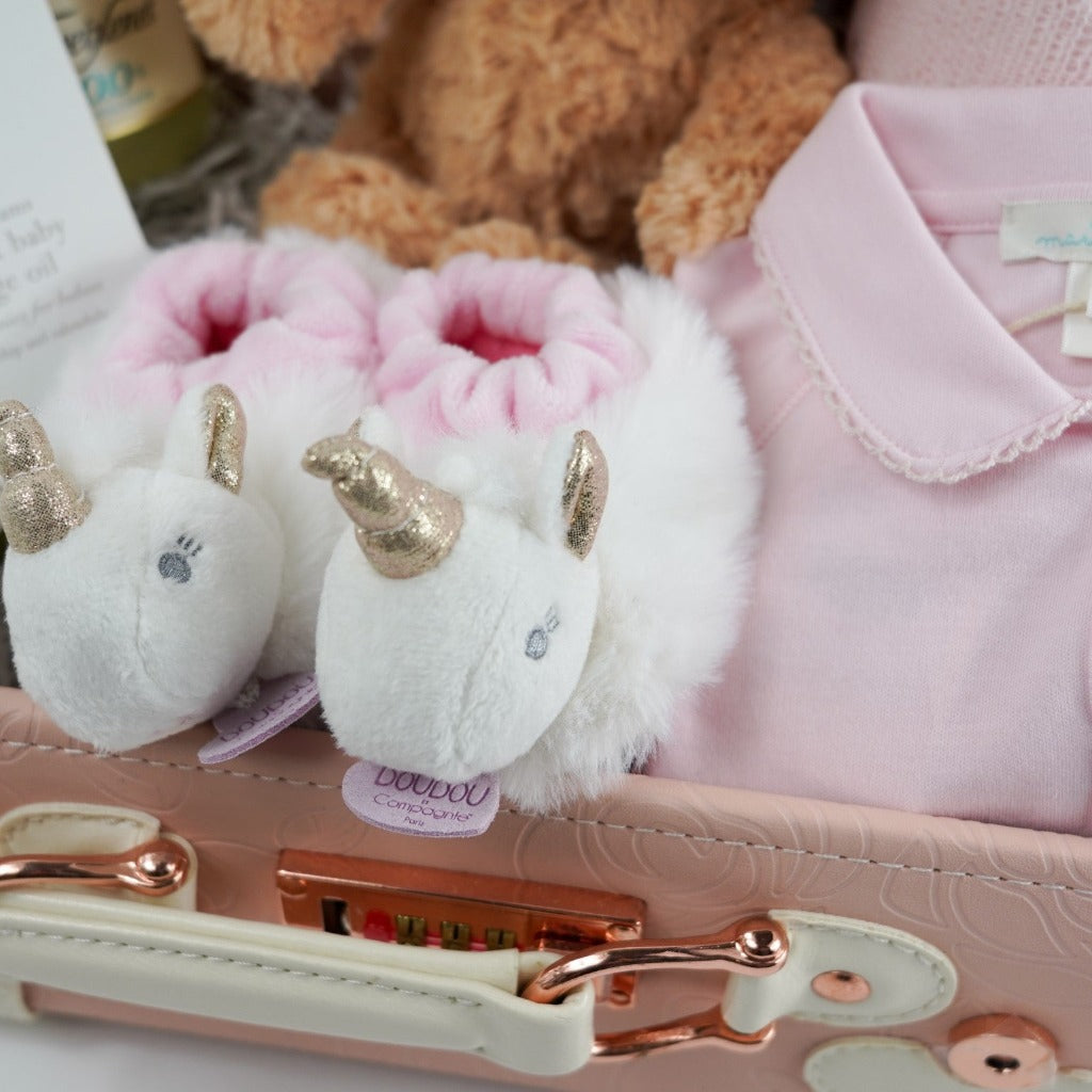 Doudou Et Campagnie white and pink baby unicorn slippers with gold horn in a luxury pink baby suitcase 