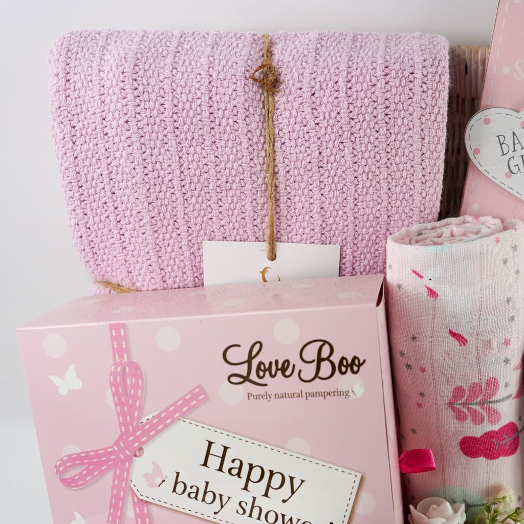 Pink themed baby shower gift hamper , baby zip up sleepsuit with unicorns in pink and white , natural baby toiletries , patel taupe rabbit with pink eats musical and matching rabbit baby comforter , unicorn pink muslin , pink heavy weight baby cellular blanket , nursery plaque