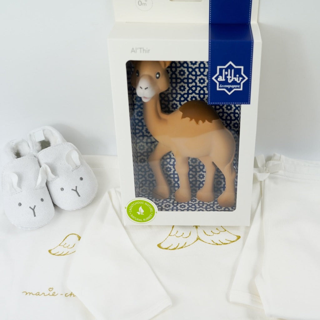 Baby wicker gift hamper, luxury cream baby clothing set with gold angel wings design, camel rubber teether, white baby slippers with animal face, grey and white baby dream blanket, steiff baby teddy in stipe pyjamas, baby milestone cards