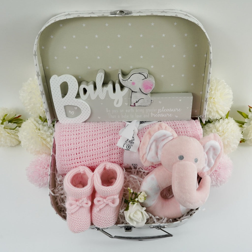 Pink elephant rattle, soft pink cellular blanket, bootees and nursery plaque in a gift case 