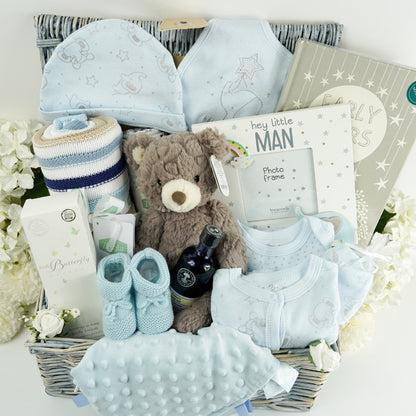 baby set in pale blue with silver elephants , soft brown teddy bear, baby journal  book, mum and baby toiletries by Little butterfly london and neals yard , baby blanket in blue and beige stripes 