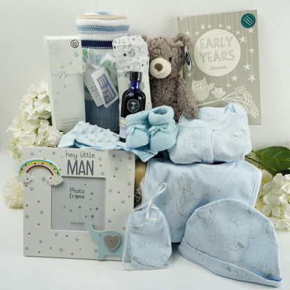 baby set in pale blue with silver elephants , soft brown teddy bear, baby journal book, mum and baby toiletries by Little butterfly london and neals yard , baby blanket in blue and beige stripe