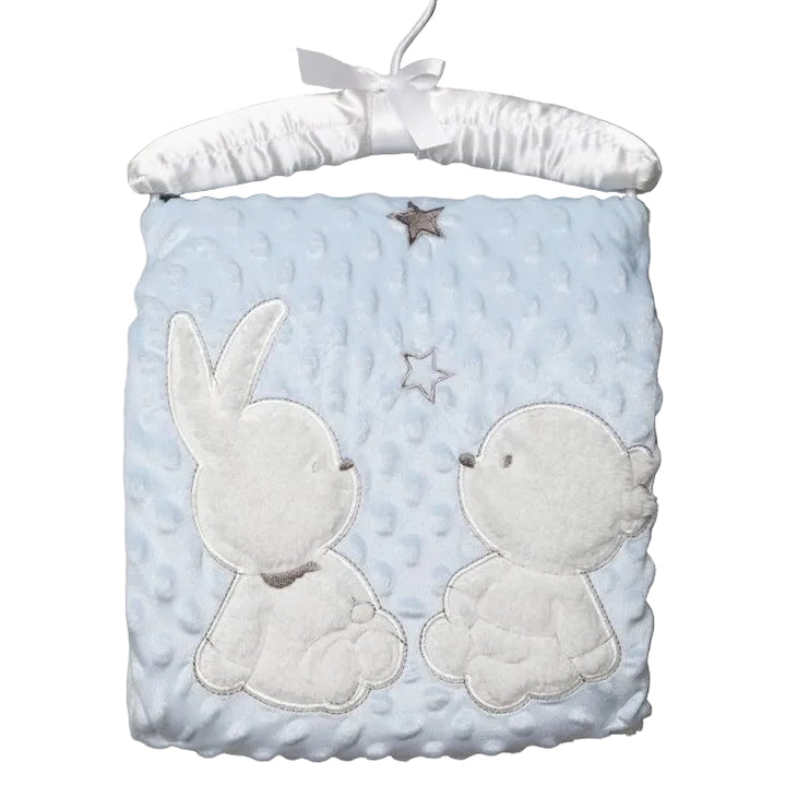 A baby blanket with applique of a bear and a rabbit on a satin padded baby coat hanger, in a pale blue color with a sherpa backing.